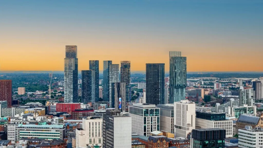 A stunning sunset view of modern skyscrapers in Manchester's bustling city center.