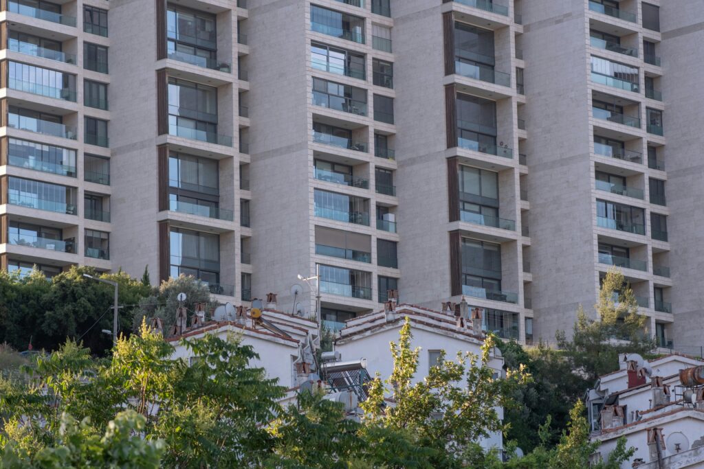 High-rise residential building facade with trees in Bornova, İzmir.